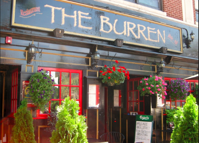 The Burren exterior — brick building with red doors and flower boxes